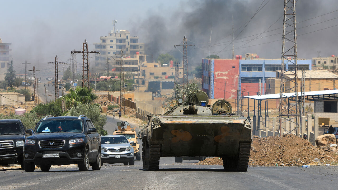 Members of Syria's security forces drive through the predominantly Druze city of Suwayda on July 15, 2025, following Israeli bombardment amid clashes between Bedouin tribes and Druze fighters.