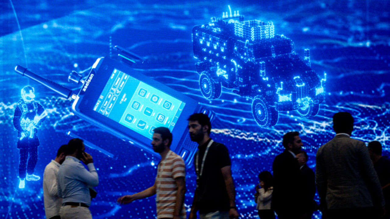 People walk past a stand at Turkey's 17th International Defense Industry Fair (IDEF) In Istanbul on July 24, 2025 in Istanbul, Turkey. (Chris McGrath/Getty Images)