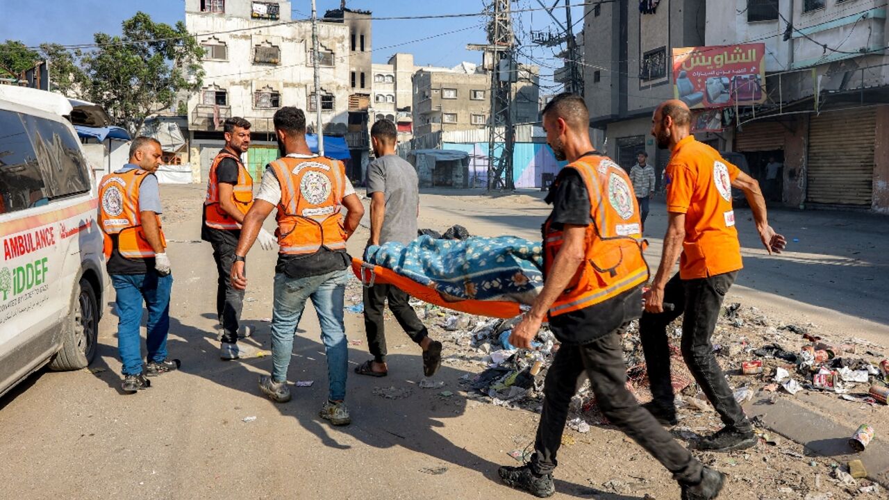 Palestinian rescuers carried a victim of an Israeli strike in Gaza City