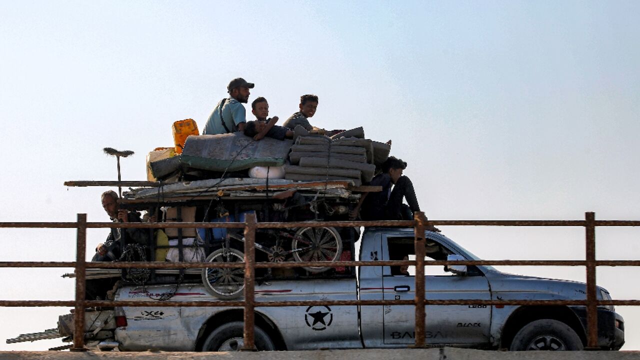 Displaced Gazans head south along a coastal road as the Israeli military gears up for a major new operation in the territory's north