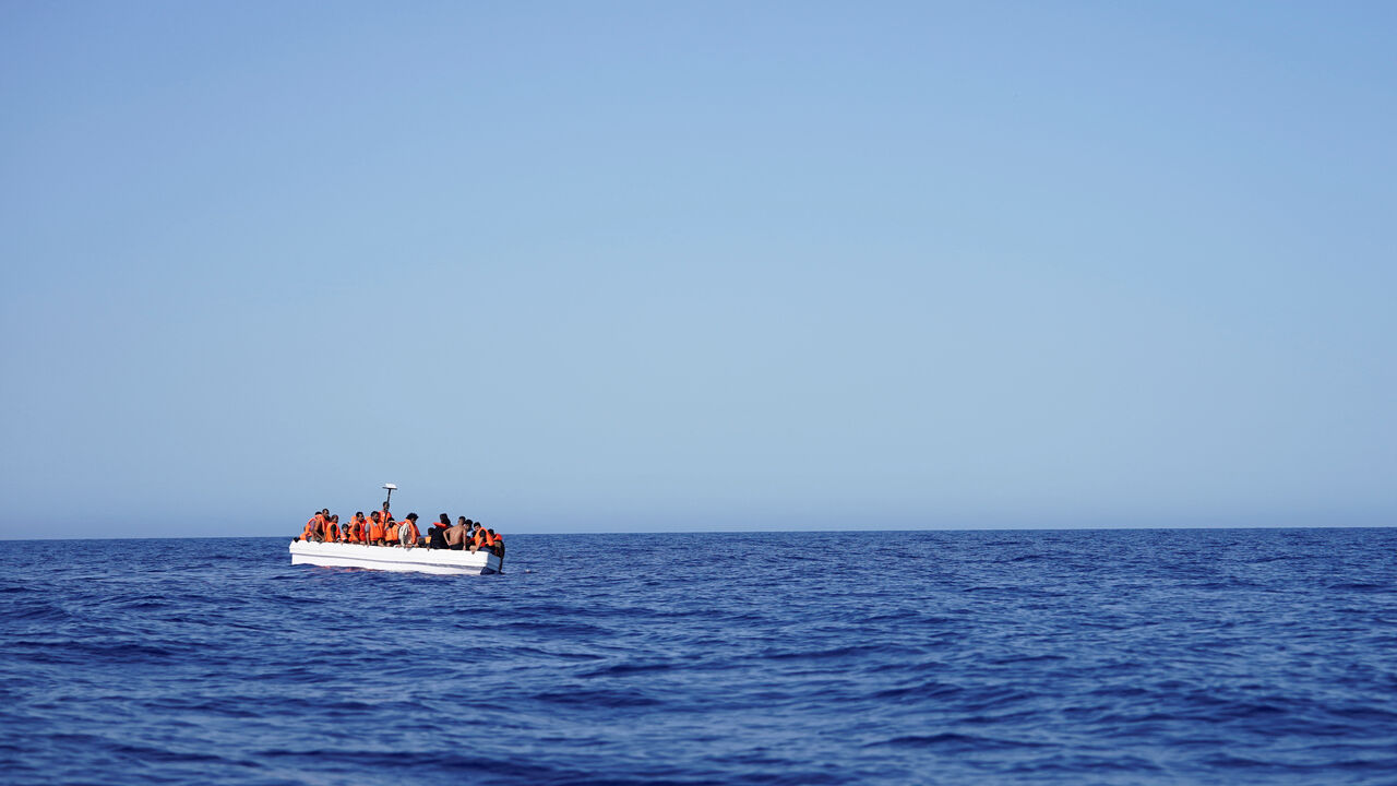 Migrants on a fiberglass boat wait to be assisted by NGO Open Arms rescue boat "Astral" in international waters south of Lampedusa, in the Mediterranean Sea, July 24, 2025. REUTERS/Ana Beltran/File Photo