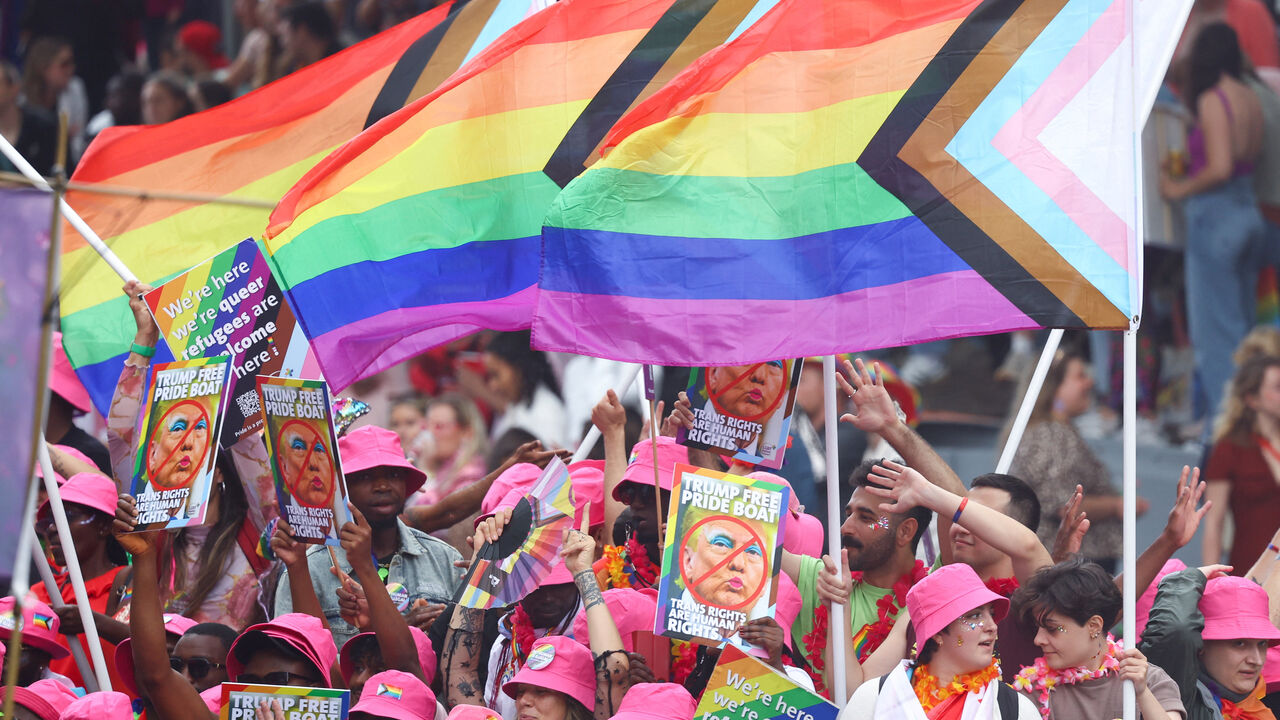 People react on a boat filled with participants, which cruises the UNESCO World Heritage recognized canals during the annual gay pride parade in Amsterdam, Netherlands August 2, 2025. REUTERS/Yves Herman