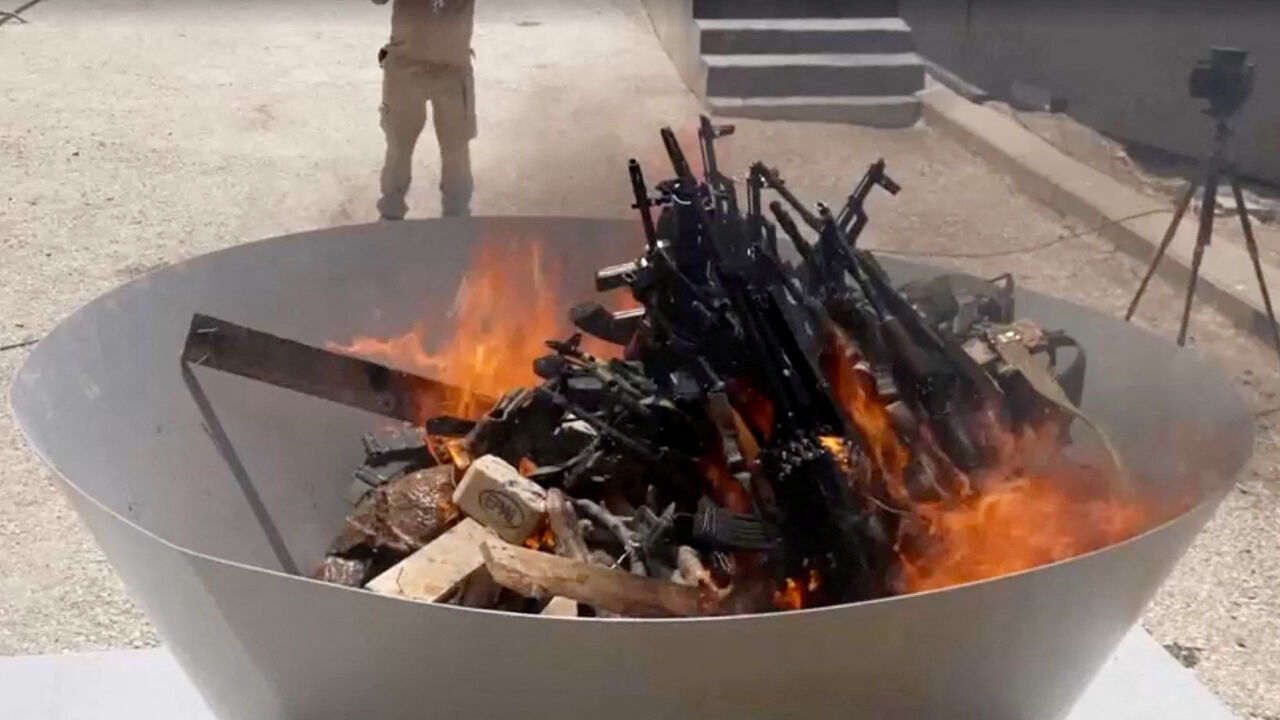 Weapons placed by PKK fighters are burnt during a disarming ceremony in Sulaimaniya, Iraq, July 11, 2025, in this screengrab obtained from a handout video. KURDISTAN WORKERS PARTY MEDIA OFFICE/Handout via REUTERS/File Photo