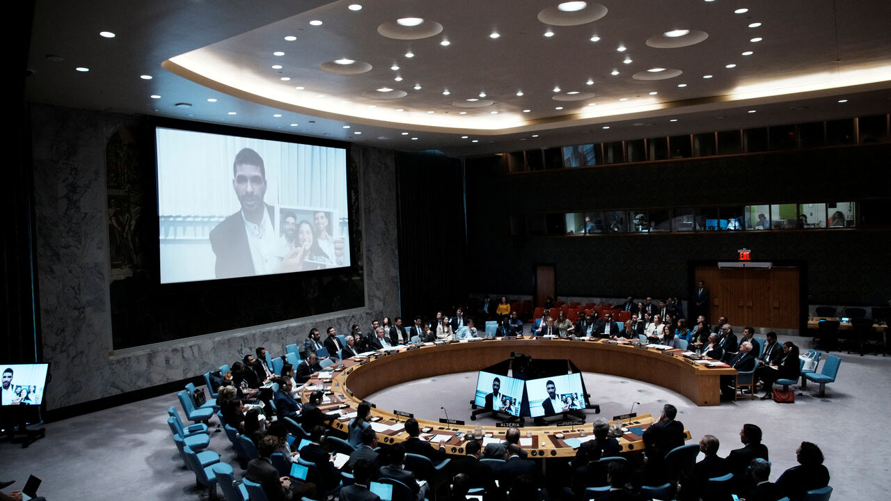 Ilay David is displayed on screen as he shows a picture of his family during a Security Council meeting at UN headquarters in New York City, U.S., August 5, 2025.  REUTERS/Eduardo Munoz