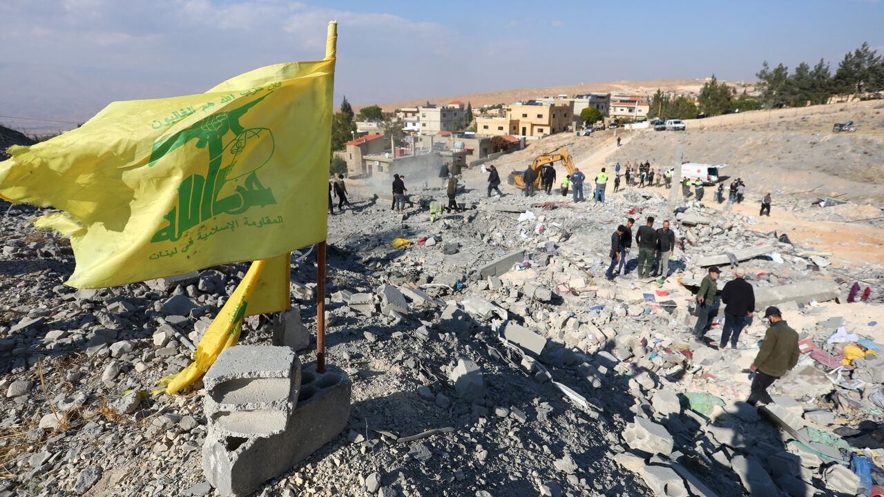 FILE PHOTO: A Hezbollah flag flutters at a site damaged in the aftermath of an Israeli strike on the town of Al-Ain in the Baalbek region, in Lebanon, November 6, 2024. REUTERS/Mohammed Yassin/File Photo