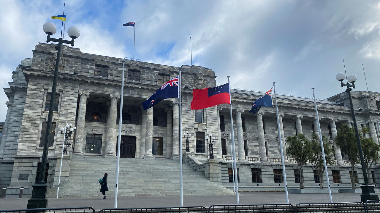 A pedestrian walks past the New Zealand Parliament Buildings in Wellington, New Zealand, June 14, 2022. REUTERS/Lucy Craymer/File Photo
