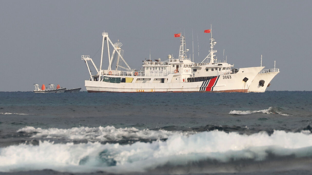 FILE PHOTO: China Coast Guard vessels are pictured at the disputed Scarborough Shoal, April 5, 2017. REUTERS/Erik De Castro/File Photo