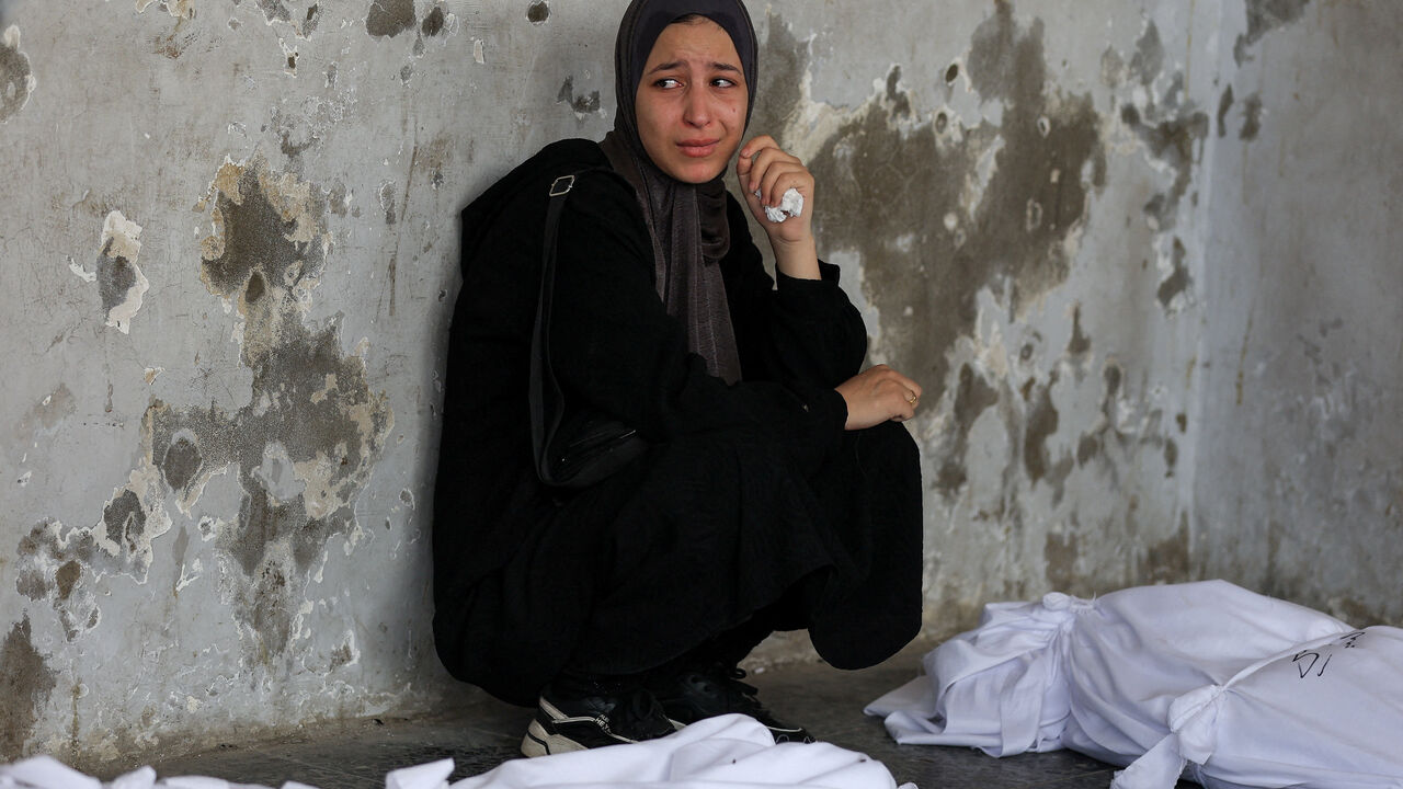 A mourner attends the funeral of Palestinians killed in Israeli strikes, according to medics, at Al-Ahli Arab Hospital in Gaza City August 12, 2025. REUTERS/Dawoud Abu Alkas     TPX IMAGES OF THE DAY