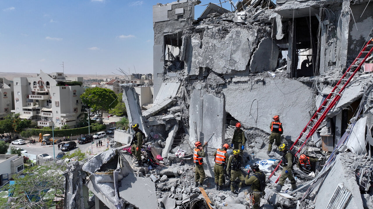 FILE PHOTO: A drone view shows emergency personnel working at an impacted residential site, following an early morning missile attack from Iran on Israel, in Be'er Sheva, Israel June 24, 2025. REUTERS/Yonatan Honig/File Photo