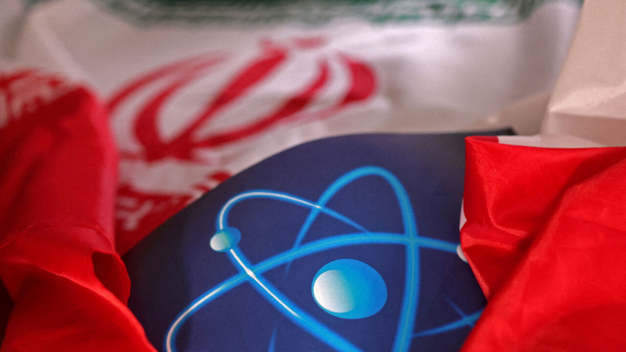 FILE PHOTO: Atomic symbol and Iranian flag are seen in this illustration taken September 8, 2022. REUTERS/Dado Ruvic/File Photo