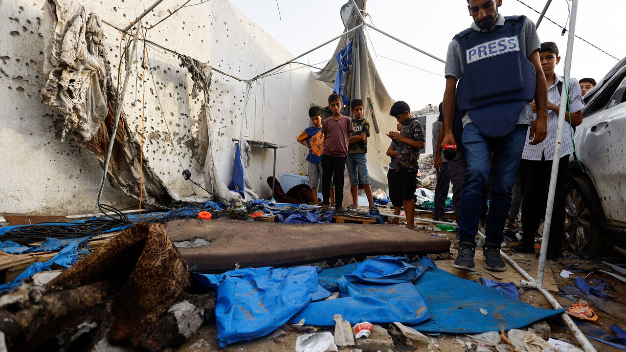 FILE PHOTO: A member of the media inspects the damage at the site of an Israeli strike on a tent near Shifa Hospital, in Gaza City August 11, 2025. REUTERS/Mahmoud Issa/File Photo