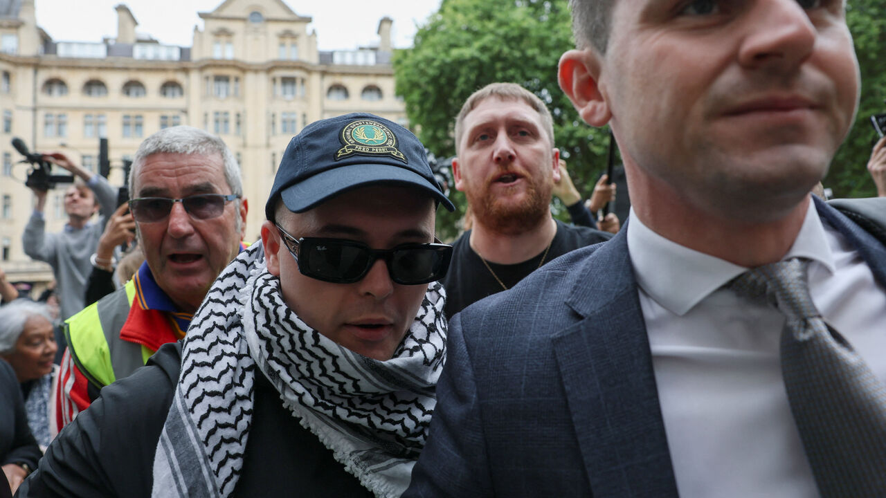 Member of Kneecap Liam O'Hanna, also known as Liam Og O hAnnaidh and performing under the name of Mo Chara, who has been charged with a terrorism offence in relation to the alleged display of a Hezbollah flag onstage in 2024, arrives at the Westminster Magistrates' Court, in London, Britain, August 20, 2025. REUTERS/Hannah McKay