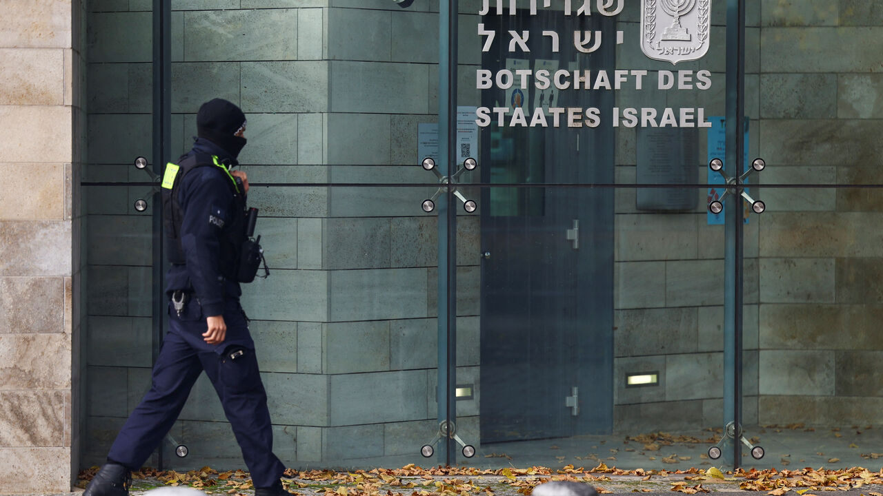 FILE PHOTO: A member of police walks next to the embassy of Israel in Berlin, Germany, October 20, 2024. REUTERS/Lisi Niesner/File Photo
