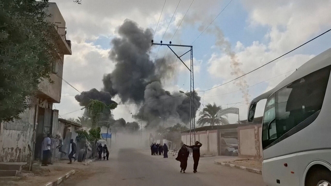 People run as plumes of smoke rise following an Israeli airstrike, amid the ongoing conflict between Israel and Hamas, in Deir al-Balah, Gaza Strip, August 21, 2025, in this screengrab obtained from a video. Video obtained by Reuters/Handout via REUTERS