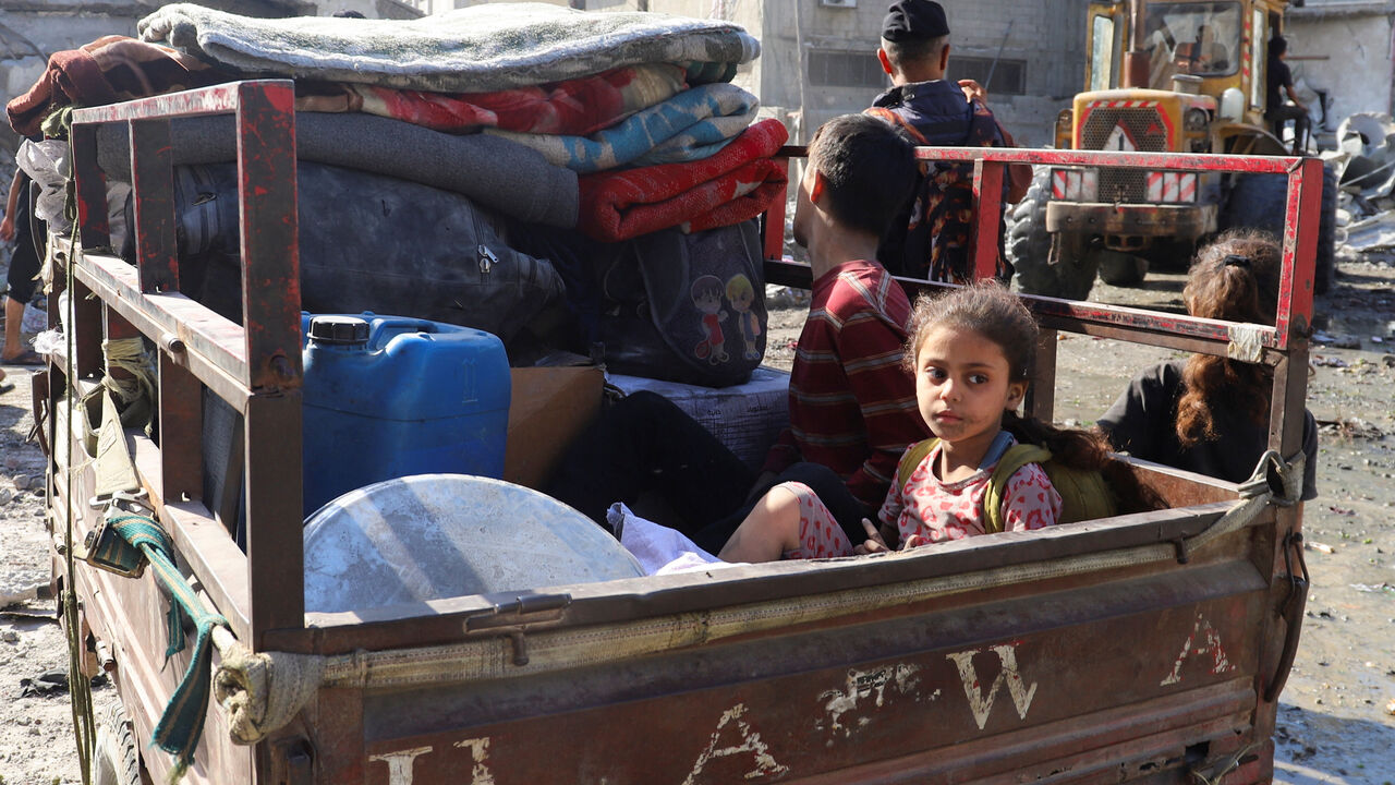A Palestinian child looks on as she sits in a vehicle, at the site of an overnight Israeli strike on a house, in Gaza City, August 26, 2025. REUTERS/Ebrahim Hajjaj