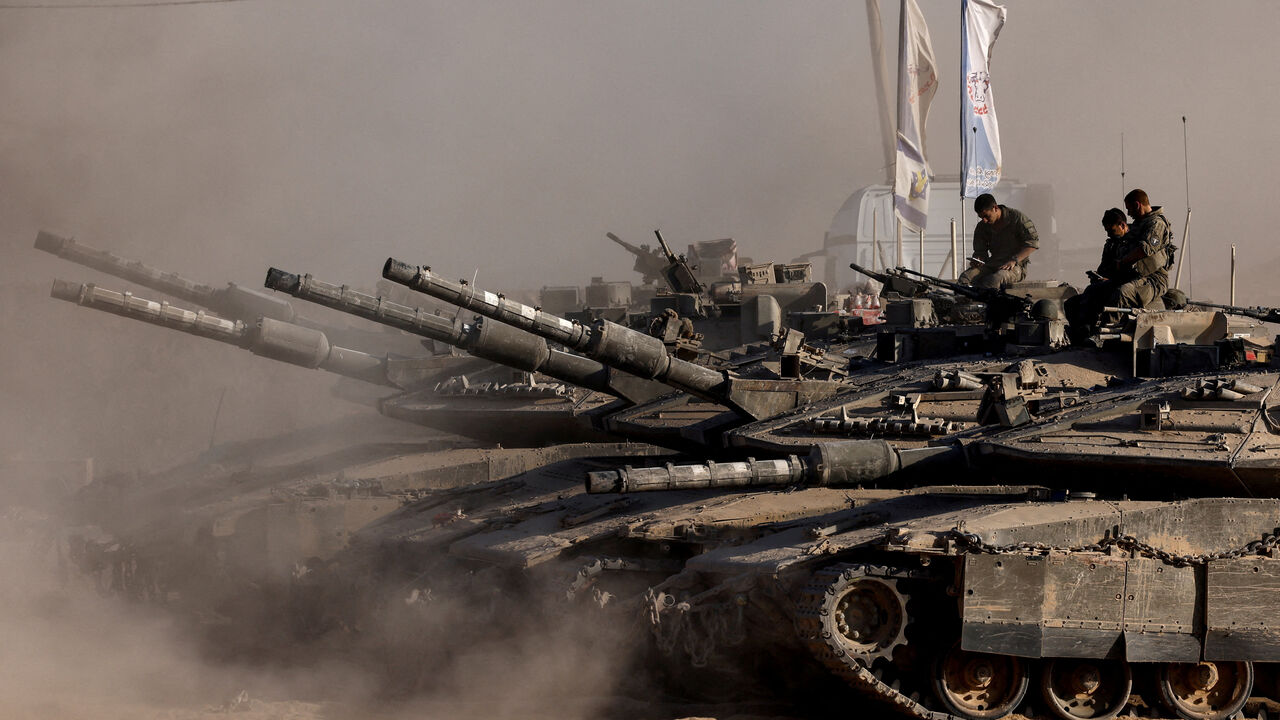 Israeli soldiers sit on top of tanks at the Israel-Gaza border, as seen from Israel, August 26, 2025. REUTERS/Amir Cohen
