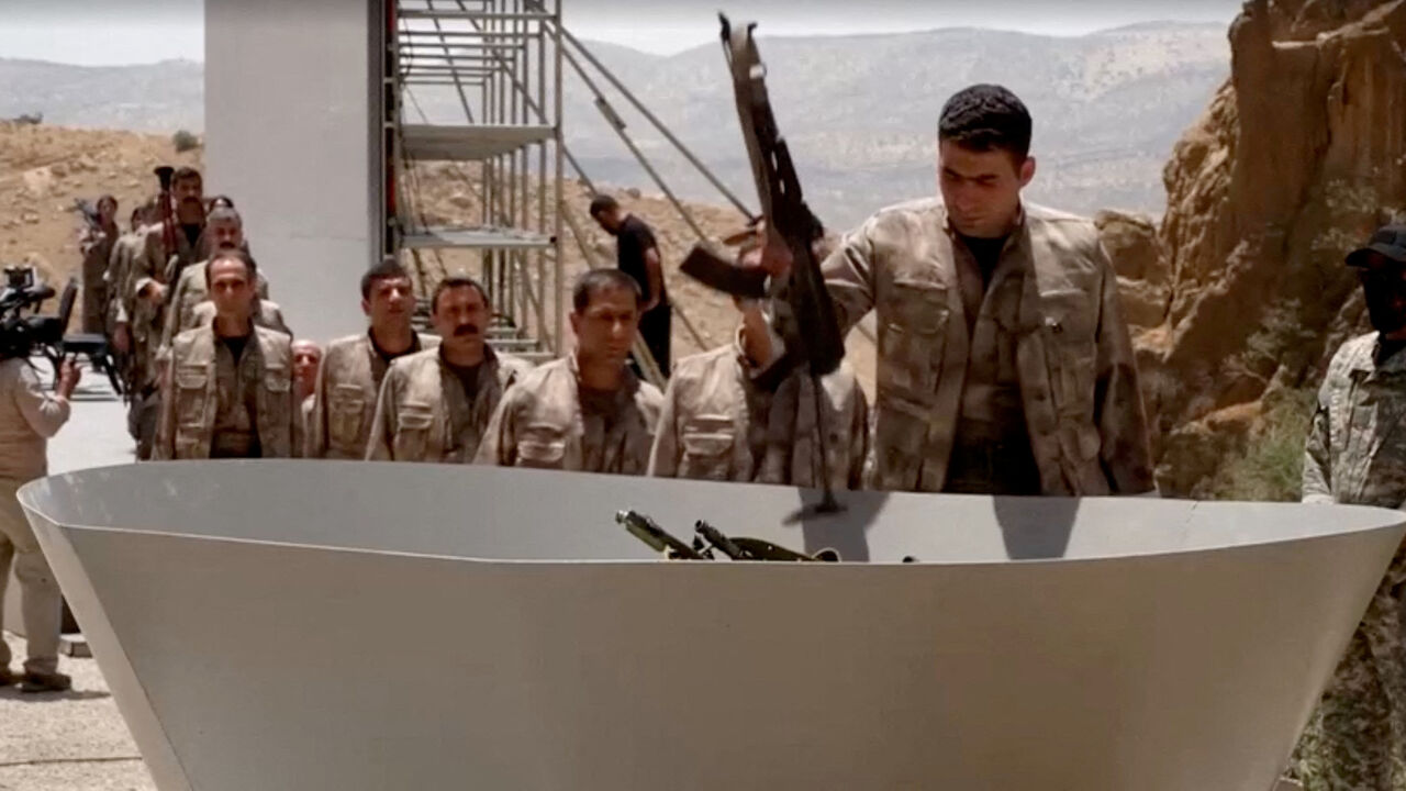 FILE PHOTO: An armed PKK fighter places a weapon to be burnt during a disarming ceremony in Sulaimaniya, Iraq, July 11, 2025, in this screengrab obtained from a handout video. KURDISTAN WORKERS PARTY MEDIA OFFICE/Handout via REUTERS/File Photo