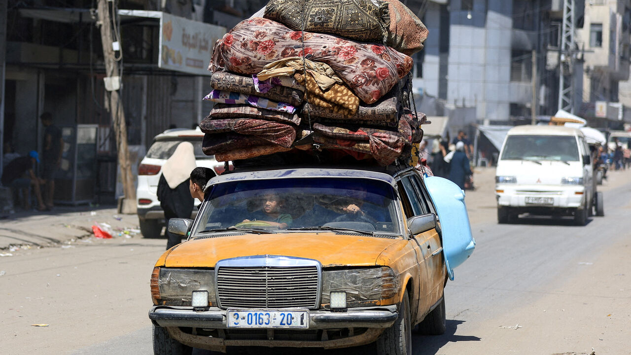 FILE PHOTO: Displaced Palestinians ride in a vehicle loaded with belongings as they flee from one area to another within Gaza City, amid an Israeli military operation, in Gaza City, August 29, 2025. REUTERS/Dawoud Abu Alkas/File Photo