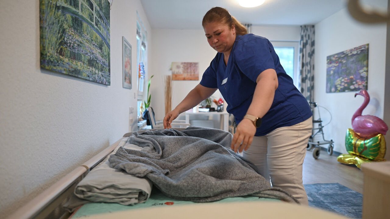 Former Syrian refugee Marwa Alshahal works at a retirement home in Altena, Germany, July 28, 2025. Alshahal was among 100 additional migrants the western German town of Altena volunteered to take in, beyond its federal quota, in an effort to revitalise a shrinking community.  REUTERS/Stephane Nitschke