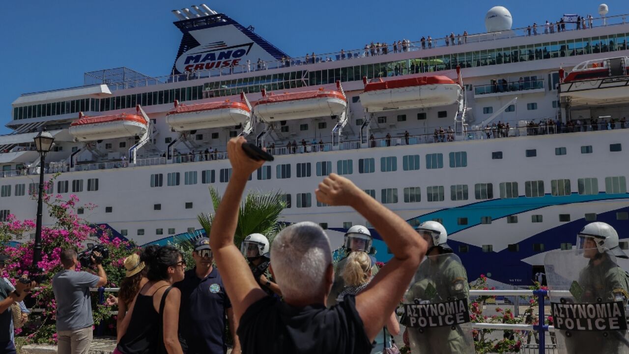Dozens of riot police armed with truncheons, tear gas and shields sealed up a cruise terminal from hundreds of demonstrators