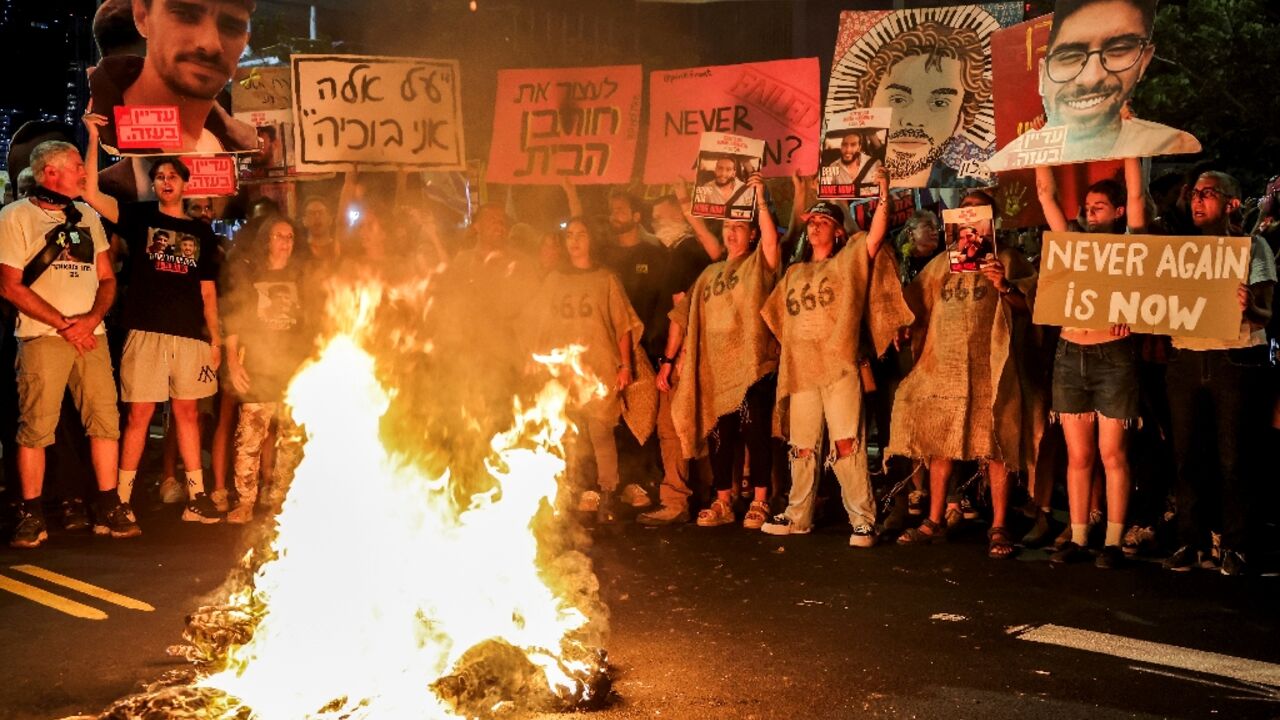 Demonstrators in Tel Aviv call for action to secure the release of hostages held in Gaza, after Palestinian groups released videos of two captives