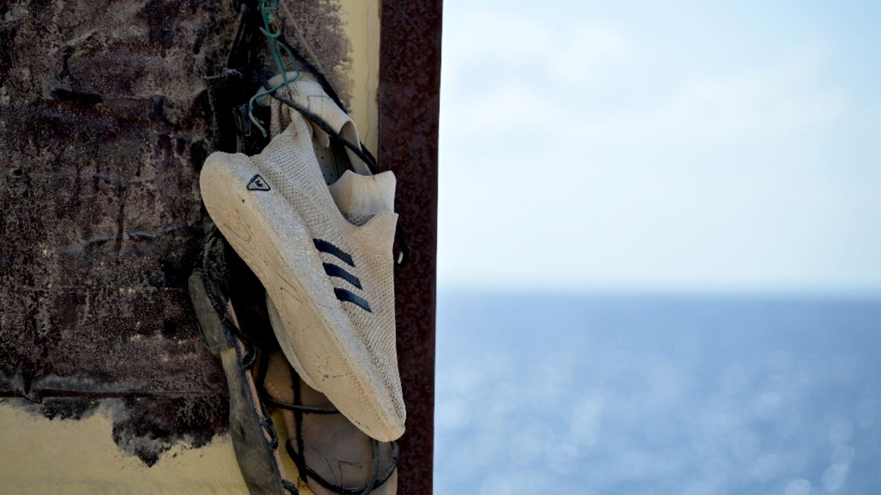 Shoes hanging on the "Porta di Lampedusa" monument, known as "The door of Europe", dedicated to the migrants who have died in the Mediterranean sea trying to reach Europe, on September 25, 2023 on the Italian island of Lampedusa