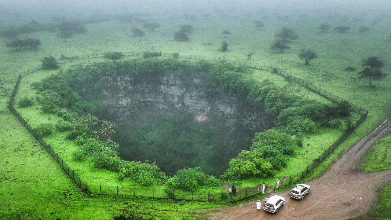 The sheer drop of the Sheeheet pit, one of four that dot Oman's Dhofar region, is ringed with slippery mud, prompting the authorities to put up a fence and warning signs.