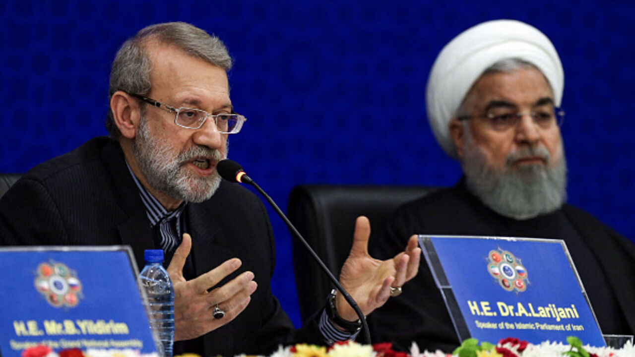 IRAN-SANCTION-DIPLOMACY-POLITICS Iran's Parliament Speaker Ali Larijani (L) speaks while seated next to President Hassan Rouhani, during the 2nd Speaker's Conference, which includes delegations from Afghanistan, China, Pakistan, Turkey, and Russia and focuses on terrorism and regional cooperation, in the capital Tehrnan on December 8, 2018. Rouhani said US sanctions were "economic terrorism", as he sought to foster a united front from visiting regional officials on December 8. Addressing parliament speakers