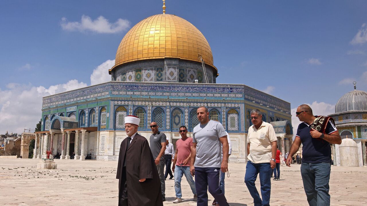 Muhammad Ahmad Hussein (L), the Grand Mufti of Jerusalem, walks in front of the Dome of the Rock mosque following Friday prayers in Jerusalem's al-Aqsa mosque complex, on September 10, 2021. 