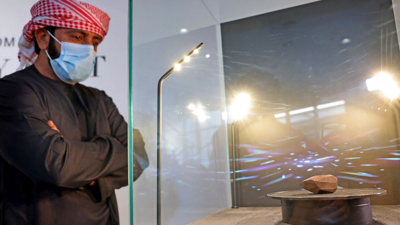 A picture taken on Jan. 17, 2022, shows "The Enigma," a 555.55-carat black diamond, at Sotheby's in the Gulf emirate of Dubai. 