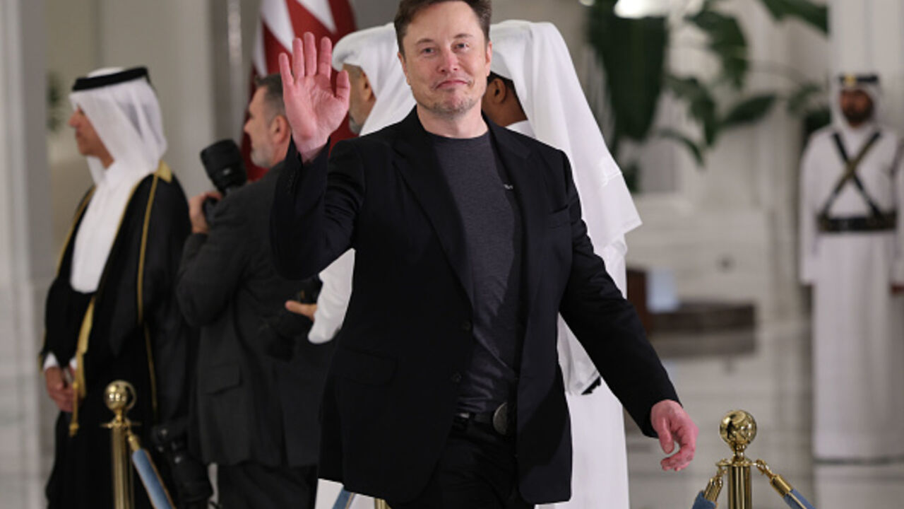 DOHA, QATAR - MAY 14: Elon Musk waves as he arrives for a state dinner at the Lusail Palace on May 14, 2025, in Doha, Qatar. The visit underscores the strategic partnership between the United States and Qatar, focusing on regional security and economic collaboration. (Photo by Win McNamee/Getty Images)