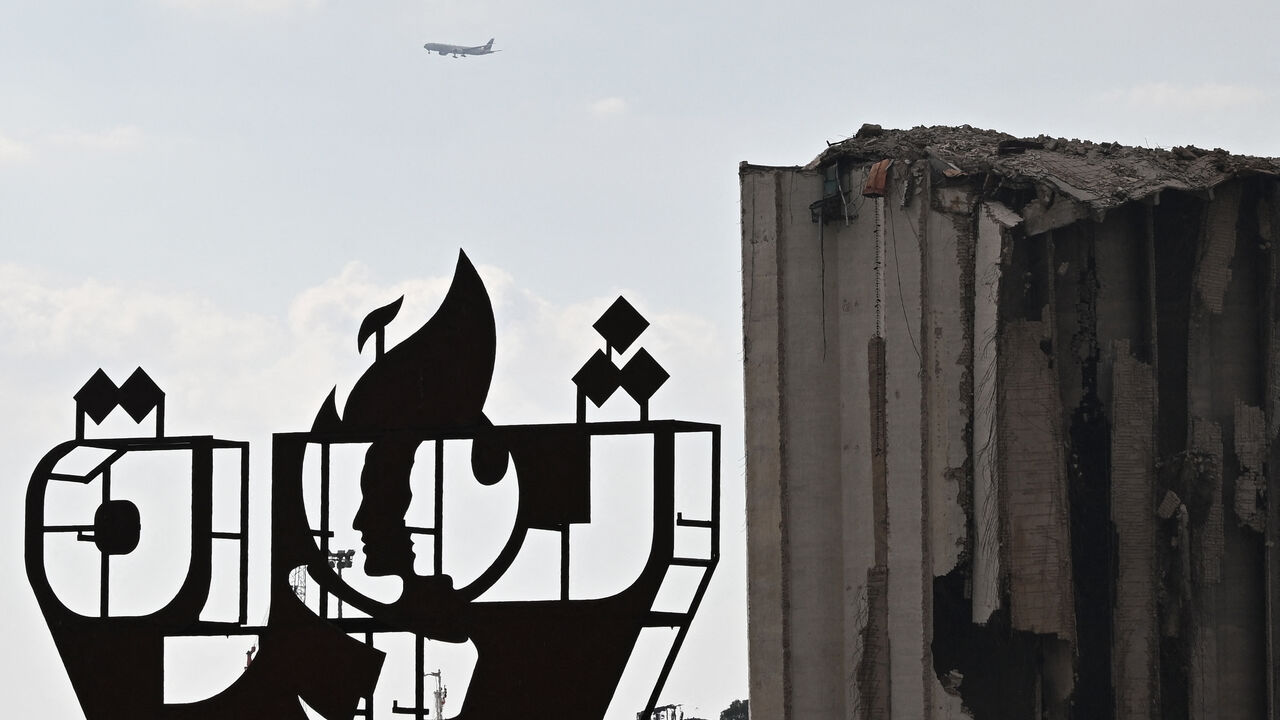 A picture shows a metal installation set up across from the destroyed Beirut port silos during a gathering to honour the victims of the catastrophic port explosion in 2020 and to call for accountability for the blast, in Beirut on August 4, 2025. Lebanese President Joseph Aoun on August 4, vowed justice and accountability five years after a catastrophic explosion at Beirut's port, as the investigating judge finished questioning defendants, a judicial official said. (Photo by JOSEPH EID / AFP) (Photo by JOSE