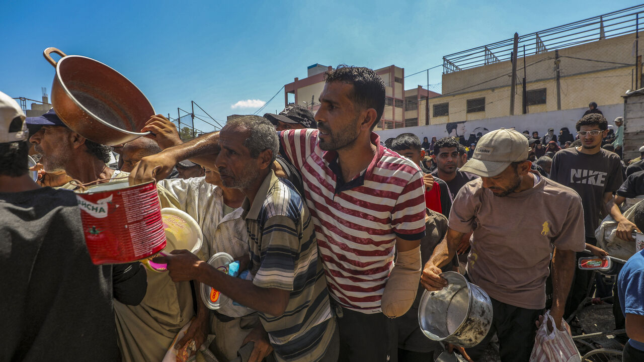 Peoples waits near a humanitarian aid distribution point at the Nuseirat refugee camp in central Gaza on July 20, 2025, amid a deepening food crisis. 