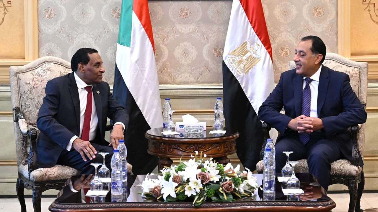 Egypt's prime minister, Mostafa Madbouly (R), meets with his counterpart from Sudan, Kamil Idris, upon his arrival in Egypt's capital, Cairo, on Aug. 7, 2025.
