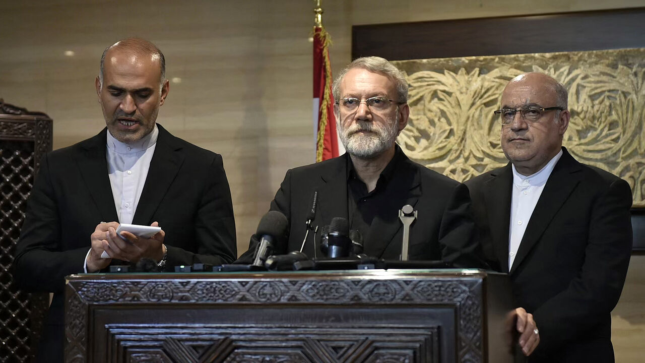 Iran's Supreme National Security Council chief Ali Larijani (C) speaks to reporters after meeting with Lebanon's parliament speaker in Beirut on Aug. 13, 2025. 