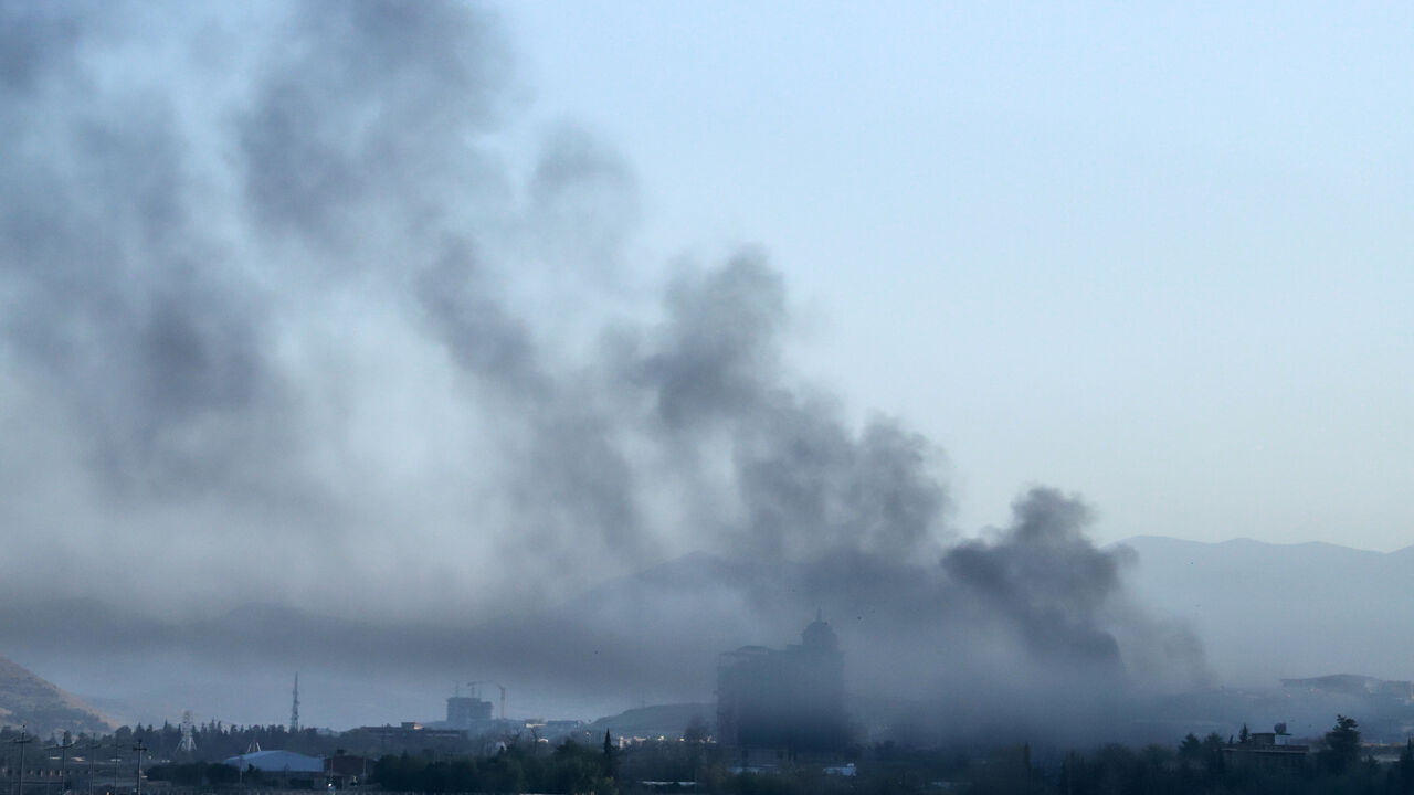 Smoke billows over a neighborhood of Sulaimaniyah, east of the autonomous Kurdistan region of Iraq, after security forces arrested opposition figure Lahur Sheikh Jangi, following several hours of armed clashes on Aug. 22, 2025.