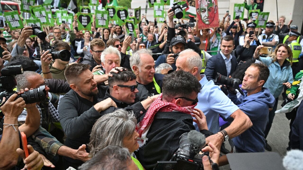 Irish rap group Kneecap band member, Naoise O Caireallain, who performs under the stage name Moglai Bap  smiles as he arrives with band mate Liam O'Hanna