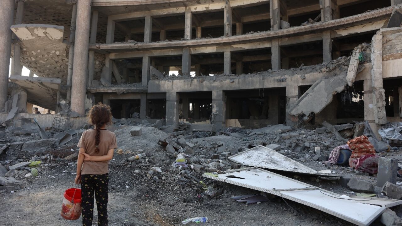 A Palestinian girl at the site of an overnight Israeli strike in Gaza City