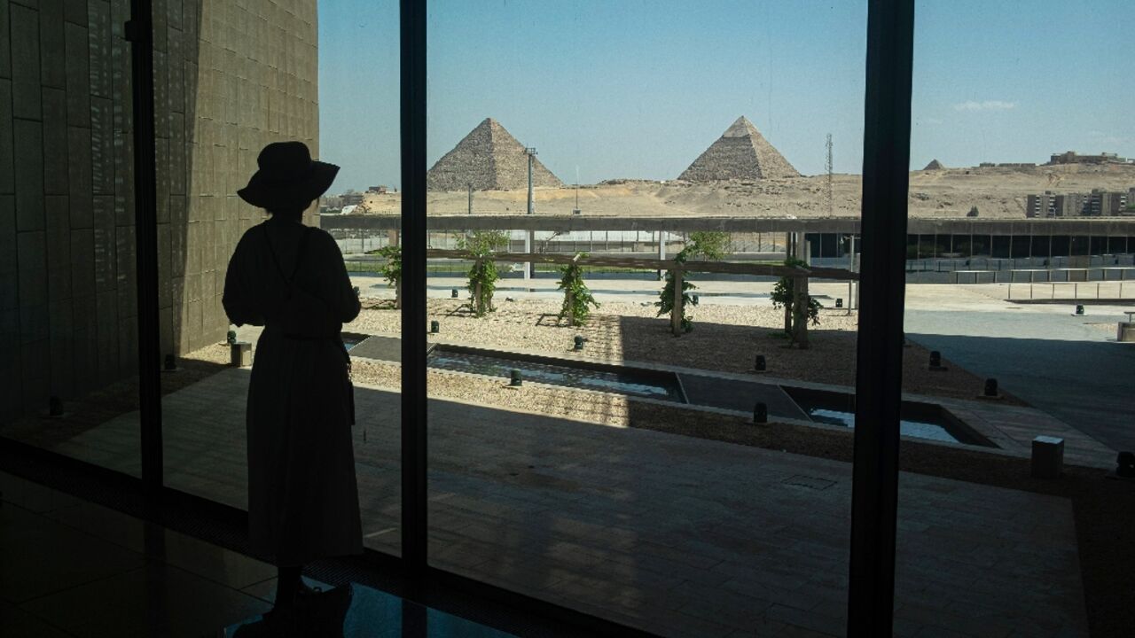A visitor looks out towards the Giza pyramid complex as she tours the Grand Egyptian Museum in Giza on the southwestern outskirts of the capital Cairo on May 5, 2025