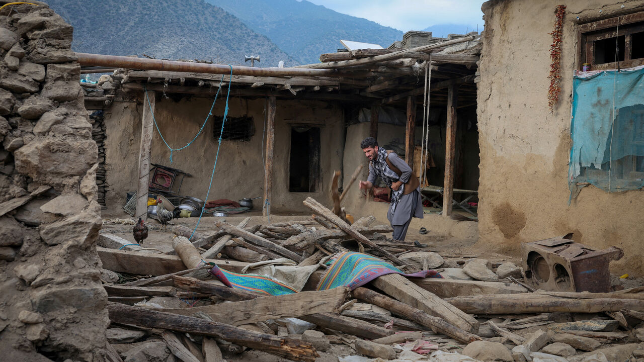 FILE PHOTO: An Afghan man looks for his belongings amidst the rubble of a collapsed house after a deadly magnitude-6 earthquake that struck Afghanistan around midnight, in Dara Noor, in Jalalabad, Afghanistan, September 1, 2025. REUTERS/Sayed Hassib/File Photo