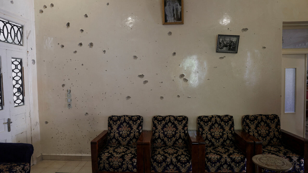 FILE PHOTO: A wall is pockmarked by bullet holes inside the Saraya family house, following sectarian violence in Syria's Sweida province, where government forces were sent to quell local clashes between Druze armed factions and Bedouin tribal fighters, in the predominantly Druze city of Sweida, Syria, July 25, 2025. REUTERS/Khalil Ashawi/File Photo