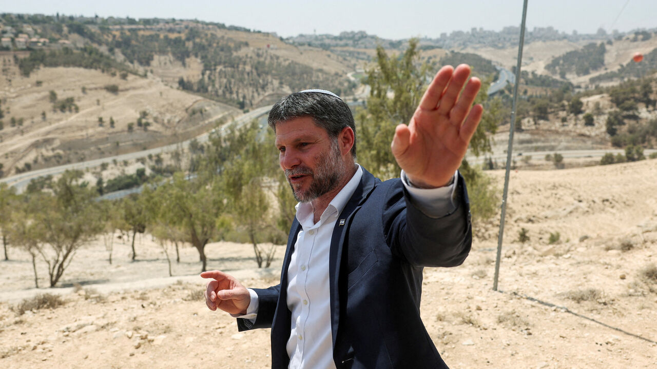 FILE PHOTO: Israeli Finance Minister Bezalel Smotrich gestures, on the day of a press conference regarding settlements expansion for the long-frozen E1 settlement, that would split East Jerusalem from the occupied West Bank, near the Israeli settlement of Maale Adumim in the Israeli-occupied West Bank, August 14, 2025. REUTERS/Ronen Zvulun/File Photo