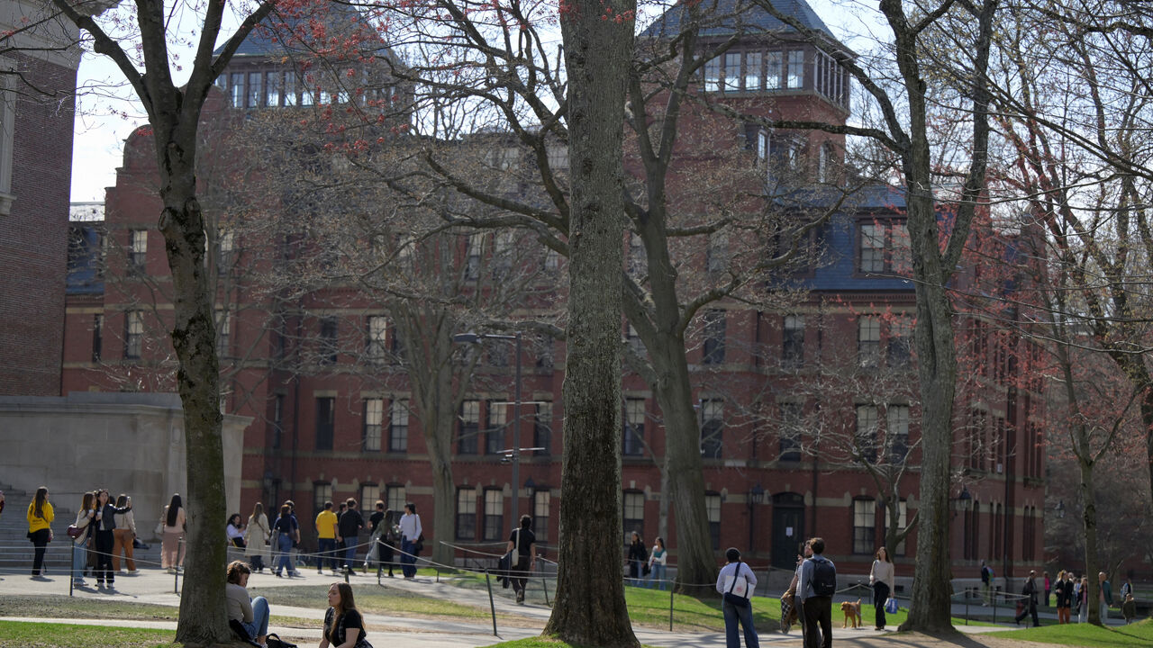 FILE PHOTO: Students gather on the campus of Harvard University in Cambridge, Massachusetts, U.S., April 15, 2025.   REUTERS/Faith Ninivaggi/ File Photo