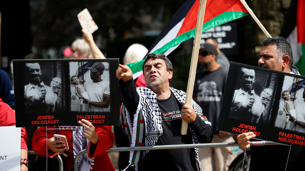 People hold Palestinian flags and signs during a protest outside the screening of the documentary "The Road Between Us: The Ultimate Rescue" about the surprise attack by Hamas on Israel, at the Toronto International Film Festival (TIFF) in Toronto, Ontario, Canada September 10, 2025.  REUTERS/Carlos Osorio