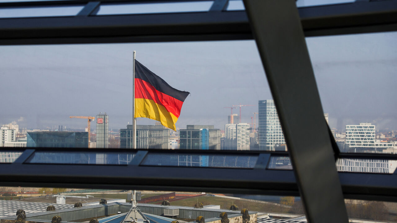FILE PHOTO: German national flag flutters on top of the Reichstag building, that seats the Germany's lower house of parliament, the Bundestag, in Berlin, Germany, March 25, 2025. REUTERS/Lisi Niesner/ File Photo