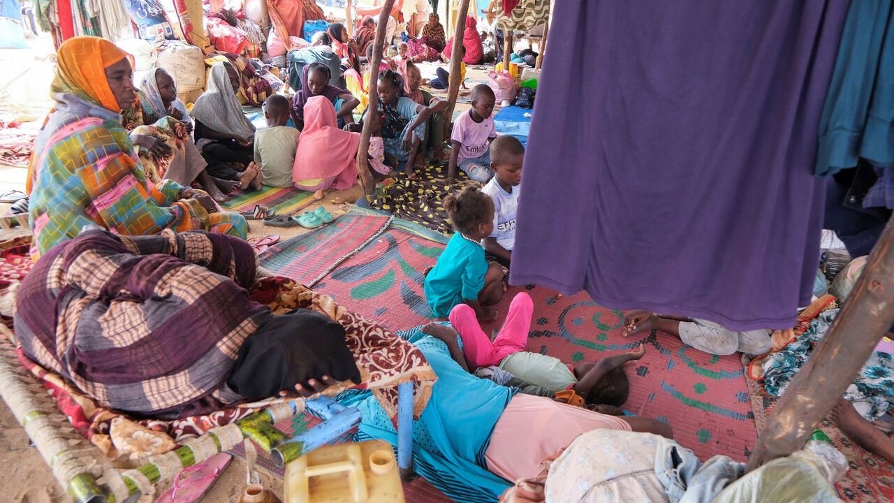 FILE PHOTO: Sudanese women who fled intense fighting in al-Fashir sit at a displacement camp, as the humanitarian situation deteriorates amid the ongoing conflict between the paramilitary Rapid Support Forces (RSF) and the Sudanese army, in Al Dabba, Sudan, September 6, 2025. REUTERS/El Tayeb Siddig/ File Photo