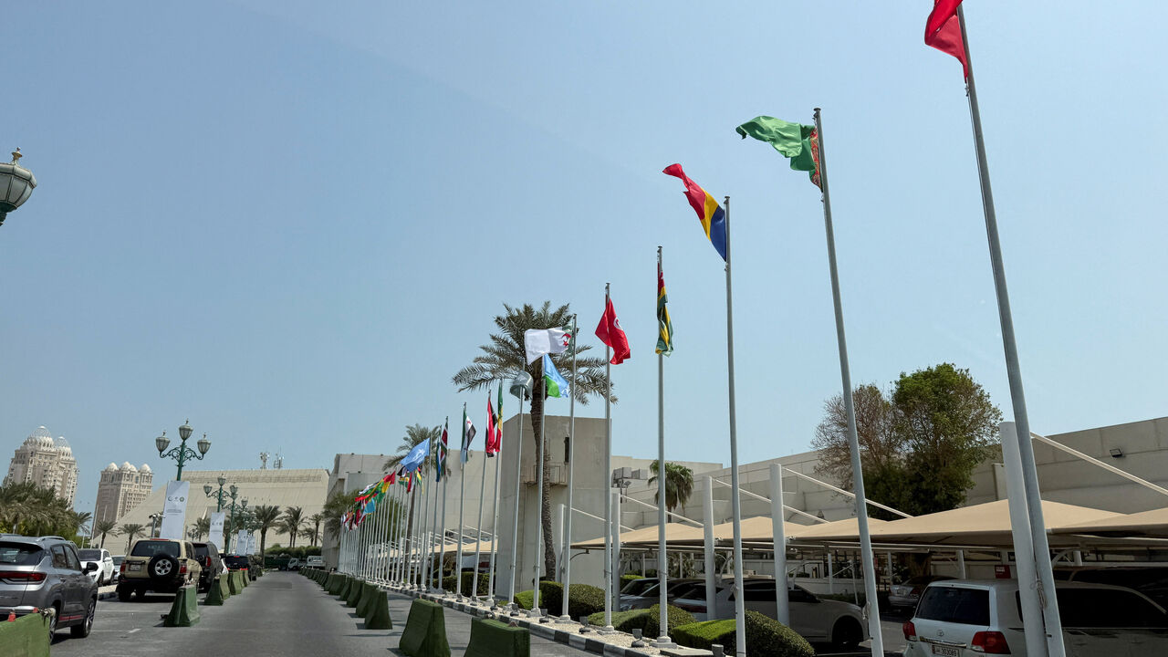 Flags flutter as Qatar prepares to host the Emergency Arab-Islamic Summit at the Sheraton Hotel, in Doha, Qatar, September 14, 2025. REUTERS/Ibraheem Abu Mustafa