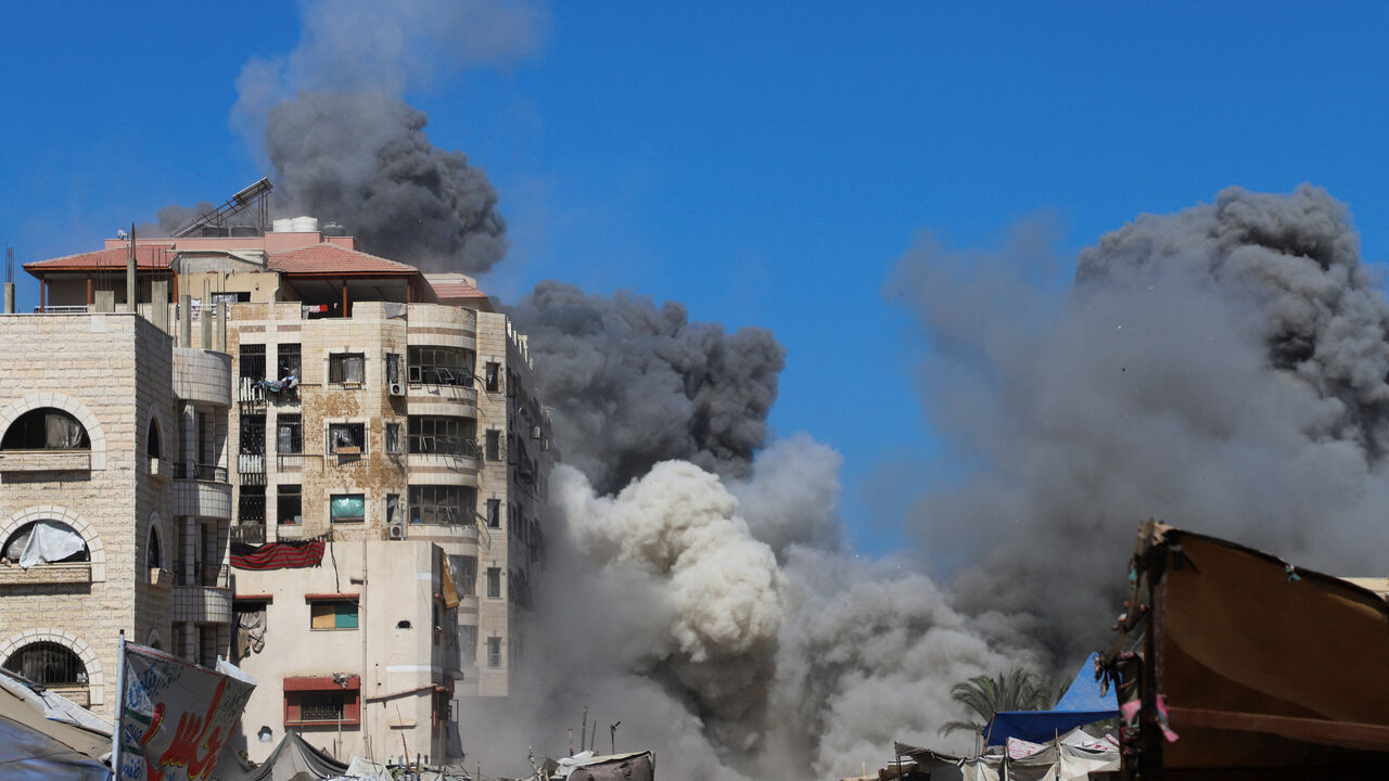 FILE PHOTO: Smoke rises from an evacuated residential building which was housing displaced Palestinians after it was hit by an Israeli air strike, in Gaza City, September 14, 2025. REUTERS/Ebrahim Hajjaj/File Photo