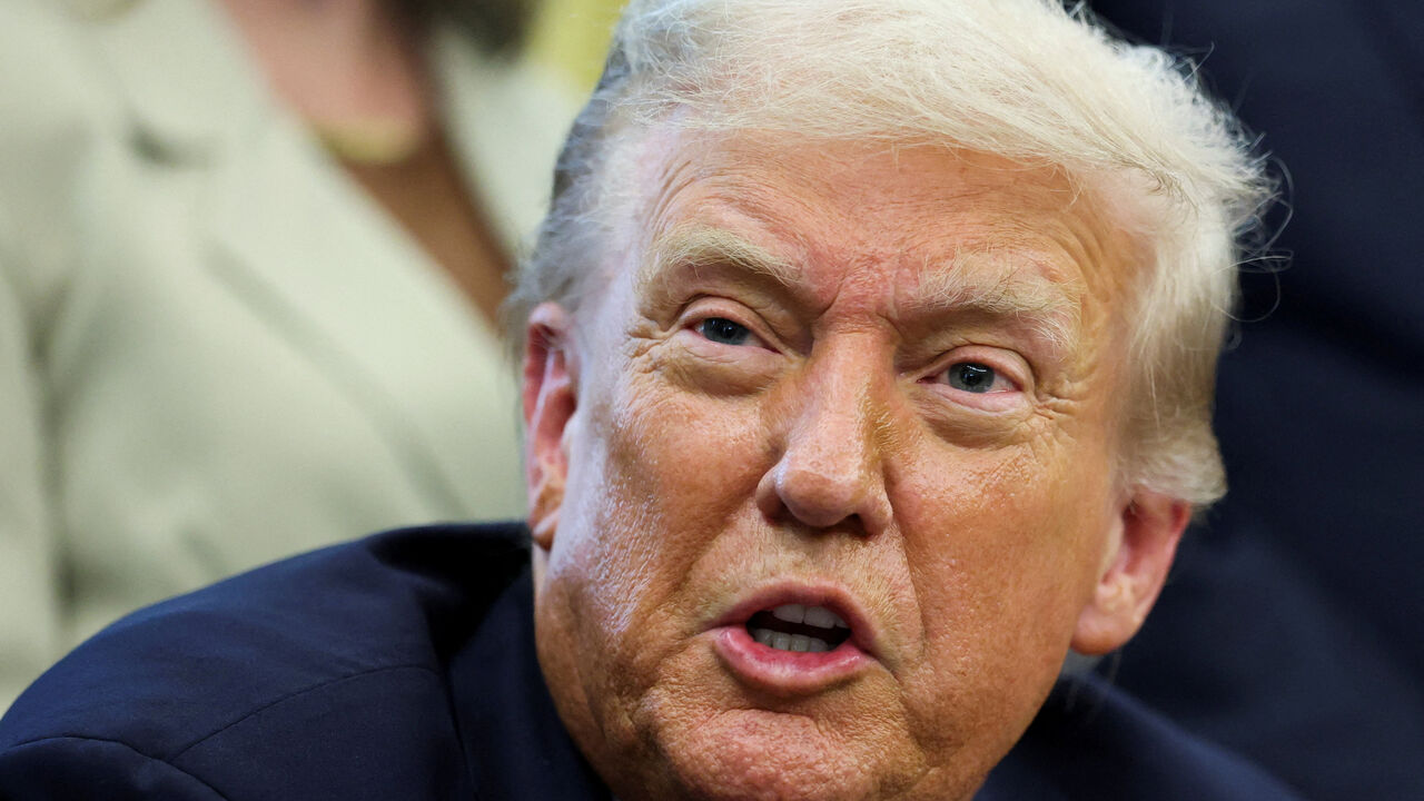 U.S. President Donald Trump reacts after signing a memorandum to send federal resources to Memphis, Tennessee, for a surge against local crime, in the Oval Office at the White House in Washington, D.C., U.S., September 15, 2025. REUTERS/Jonathan Ernst