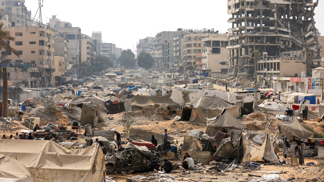 FILE PHOTO: Palestinians inspect a tent camp, which was sheltering displaced people, after it was damaged in an overnight Israeli air strike on a nearby residential building, in Gaza City, September 13, 2025. REUTERS/Dawoud Abu Alkas/File Photo
